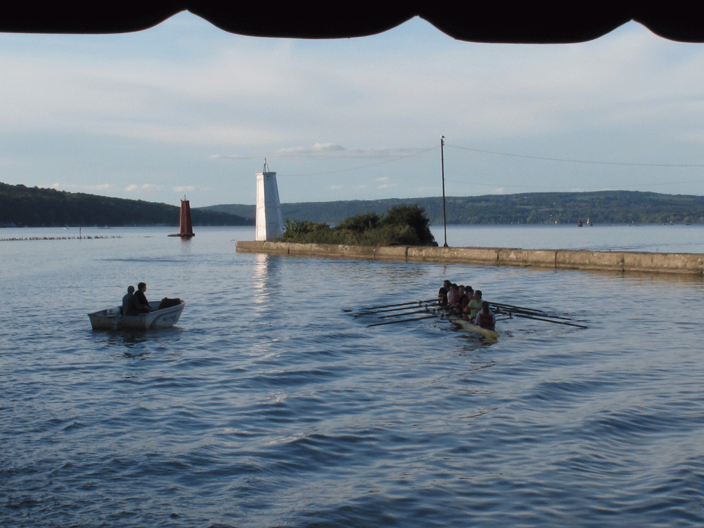Crew boat near the lighthouse Ithaca College crew boat rows near the lighthouse on Cayuga Inlet in Ithaca, NY.